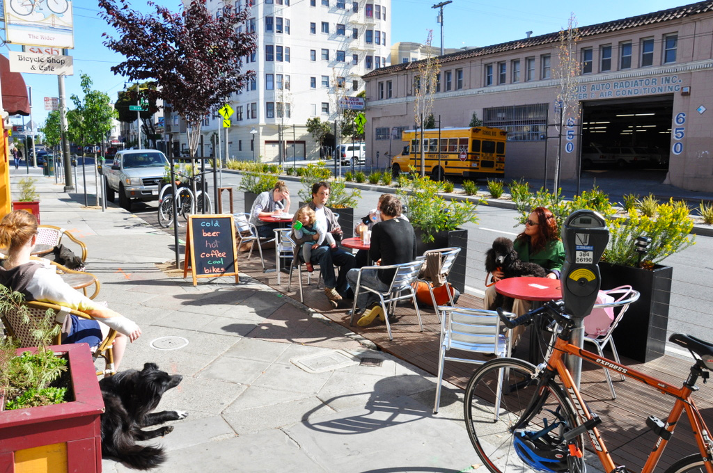 people sitting at a parklet in san francisco